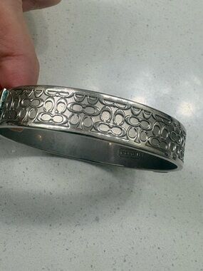 COACH Silver Tone Logo-Pattern Hinged Bangle Bracelet